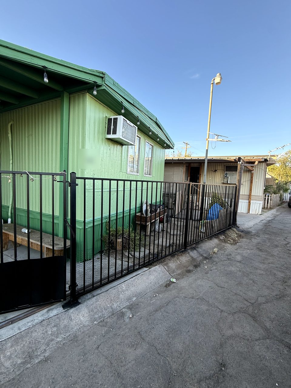 Exterior repaint: metal siding in three tones of green — Phoenix, AZ