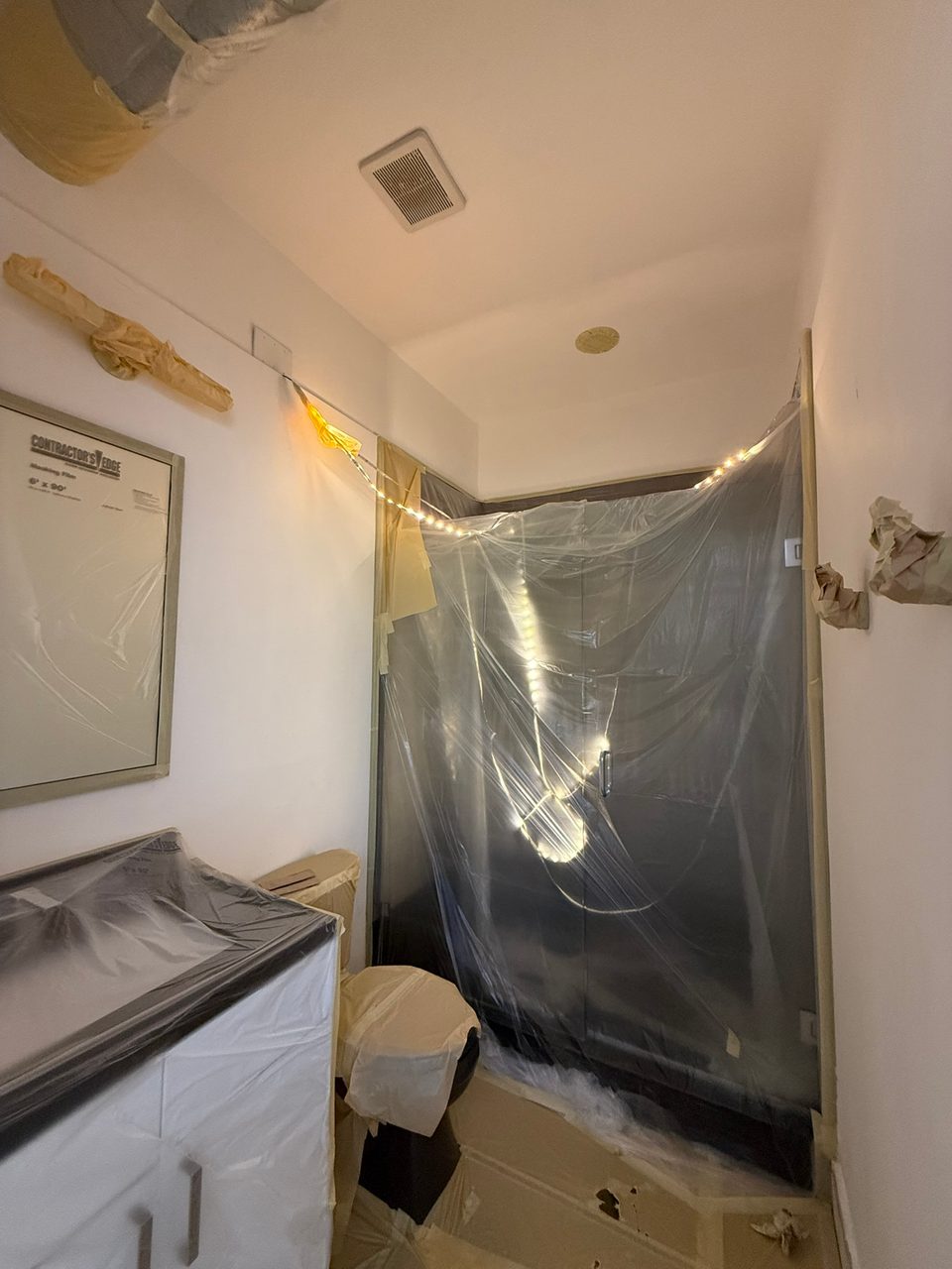A shower tented off in plastic to protect it from overspray